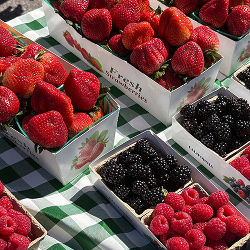 Baskets of berries on a table at a farmer's market